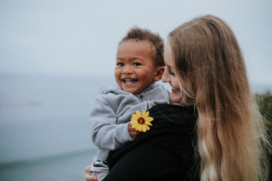 A carer and child smiling